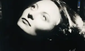 Portrait dramatique d'une femme, éclairée par le bas, évoquant l'histoire du Studio Harcourt.