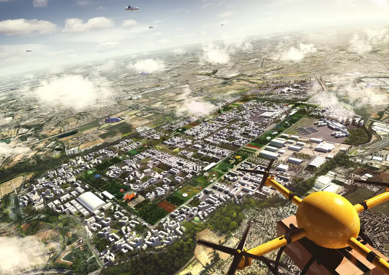 Vue a&eacute;rienne d'une ville futuriste, vue par un drone. Des b&acirc;timents modernes, des espaces verts et des infrastructures s'&eacute;tendent &agrave; perte de vue.