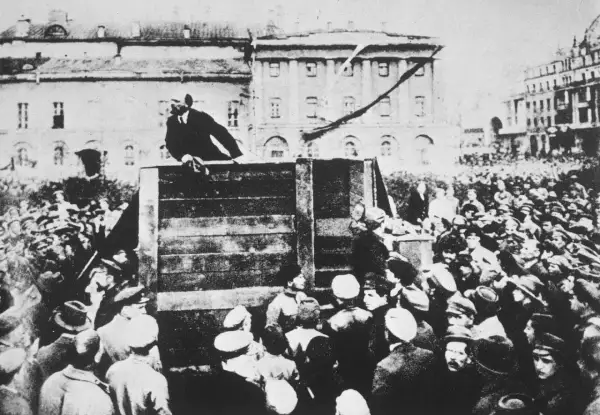 Une foule écoute un orateur sur une estrade. Une staline photo retouchée, où l'on voit un homme seul, dominant la foule.